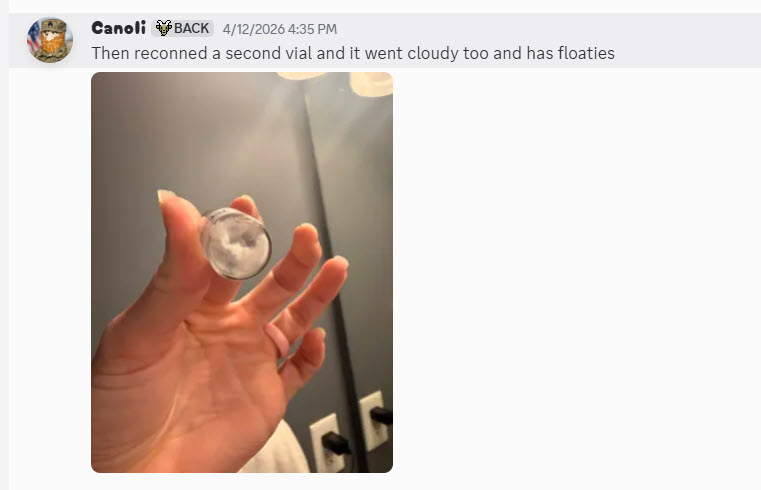A hand holding a small vial of milky, cloudy reconstituted liquid with suspended particulate; a member writes the second vial went cloudy too and has floaties.